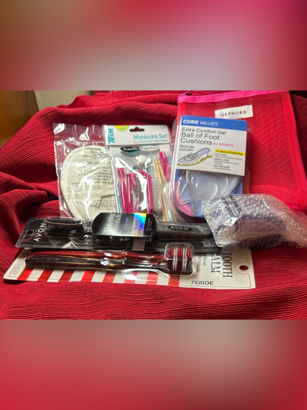 Sephora Red Mesh Pouch, with assorted beauty accessories from Avon & Trim.